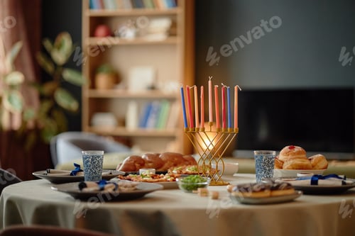 Preview: Hanukkah Table Displaying Menorah with Lit Candles and Traditional Food