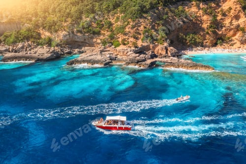 Preview: Aerial view of speed boat and sandy beach with people on sunny summer day