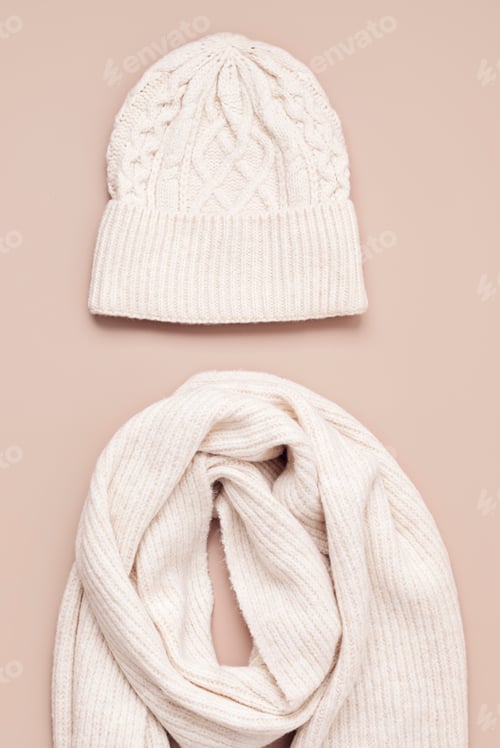 Preview: Beige woolen hat and scarf on pastel background