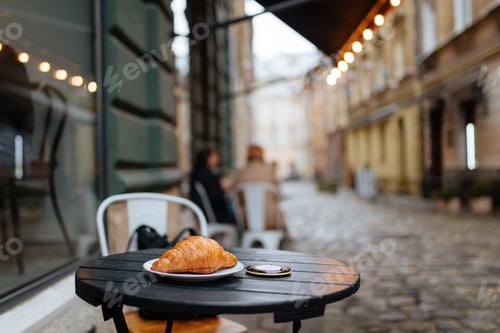 Preview: Freshly baked croissant served on cafe terrace