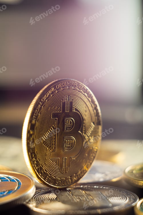 Preview: Selective focus shot of golden bitcoin standing on pile of coins