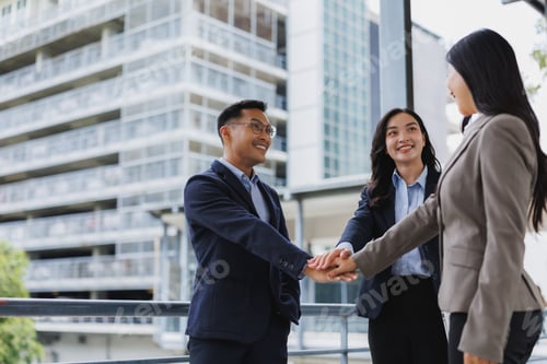 Preview: Business team joining hands in modern city, showing unity and collaboration