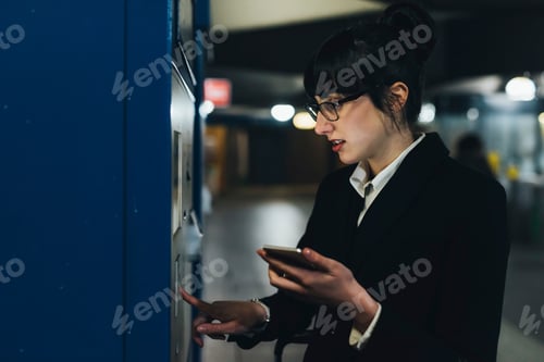 Preview: Businesswoman using ticket machine, Milan, Italy