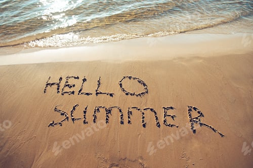 Preview: Hand drawn message Hello summer on wet yellow sand on beach of sea