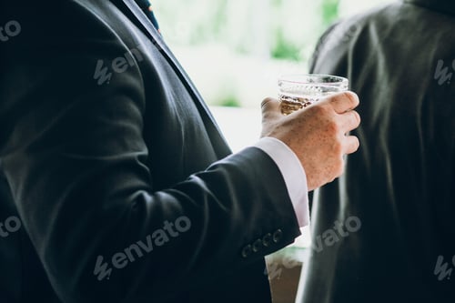 Preview: hands of stylish people cheering with glasses of whiskey