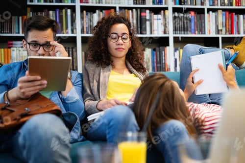 Preview: College, study, university and education concept. Group of tired students learning in library