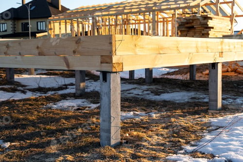 Preview: The foundation of a wooden frame house on stilts is a construction site, the process of building a f