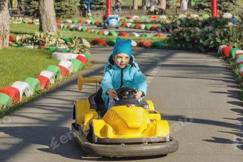 Preview: Child driving toy car on playground track