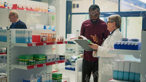 Preview: African american client giving prescription paper to pharmacist