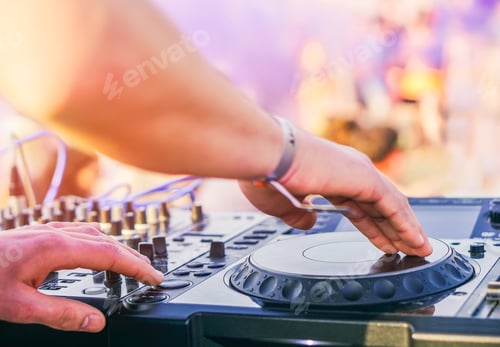Preview: Dj mixing at beach party festival with people dancing in the background