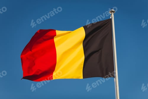 Preview: Flag of Belgium on mast. National flag against wind blue sky. Flag of Belgium, capital Bruxelless