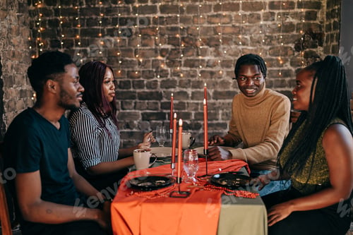 Preview: Group of 4 people celebrating Christmas winter holiday at the dinner table cheerful festive