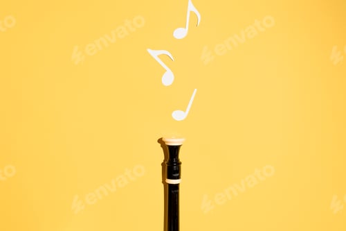 Preview: Musical flute and notes, flat lay on a yellow background. Copy space
