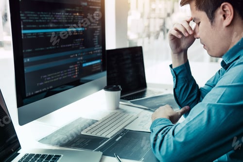 Preview: Software developers headache with code analysis in the office.