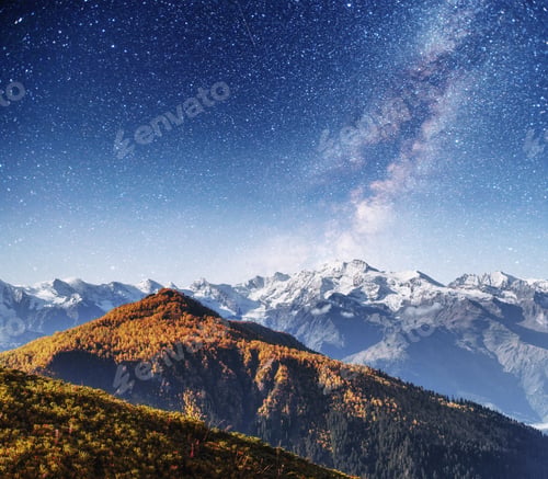 Preview: Fantastic starry sky. Autumn landscape and snow-capped peaks. Ma