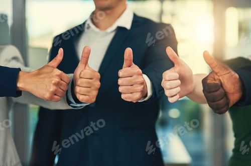 Preview: Cropped shot of a group of businesspeople giving thumbs up in a modern office