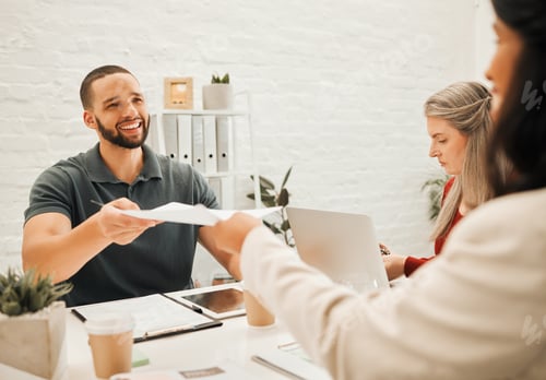 Preview: Businesspeople collaborating. Businessman giving his colleague a contract. Smiling young businessma