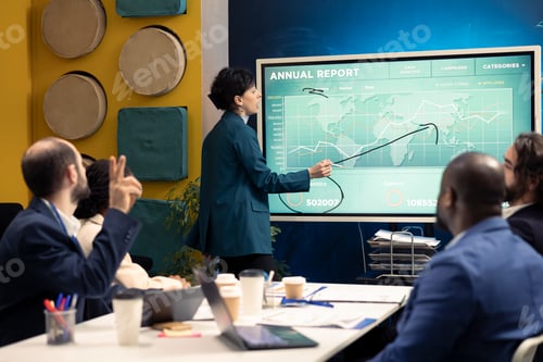 Preview: Management team studying annual infographics on interactive board