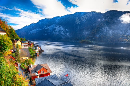 Preview: Foggy autumnal sunrise at famous Hallstatt lakeside town reflecting in Hallstattersee lake.