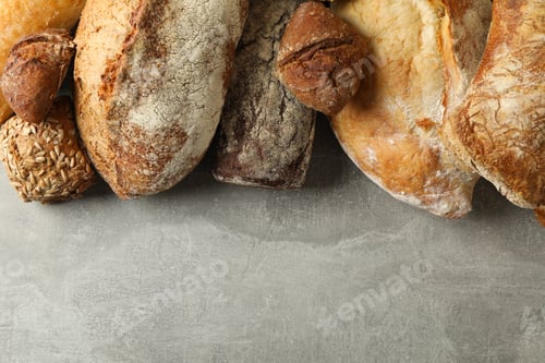 Preview: Different fresh baked bread on gray background
