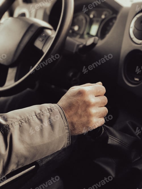 Preview: A man is driving a truck. Close-up. A man's hand switches the gear lever