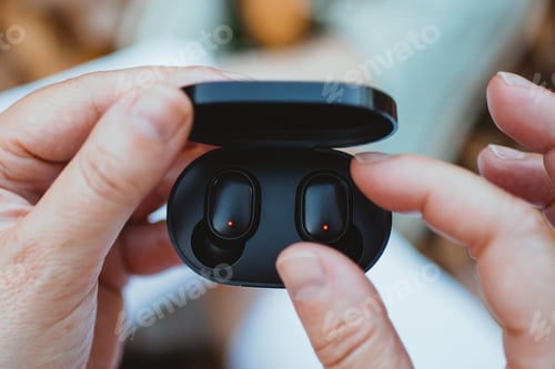 Preview: Woman taking out a wireless earbud