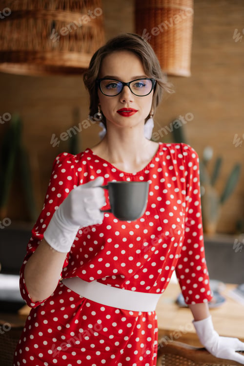 Preview: Elegant woman enjoying coffee in retro style polka dot dress