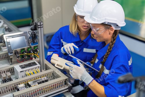 Preview: Female robotic factory workers use tablet pc quality checking Circuit Boards after assembly