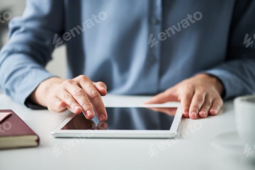 Preview: Focus on hands of young solopreneur or chief executive officer using tablet