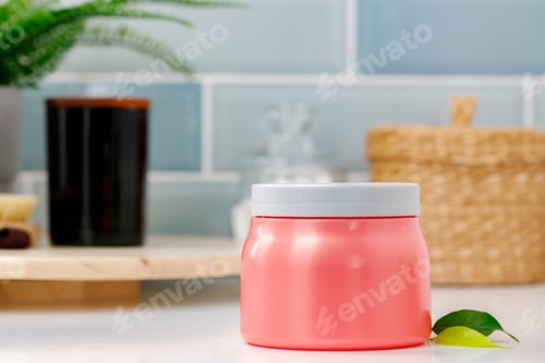 Preview: Pink skincare product jar against blue background