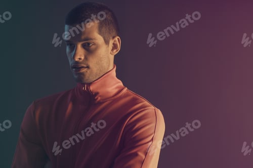 Preview: Studio close-up portrait of attractive male model. Color flash studio light