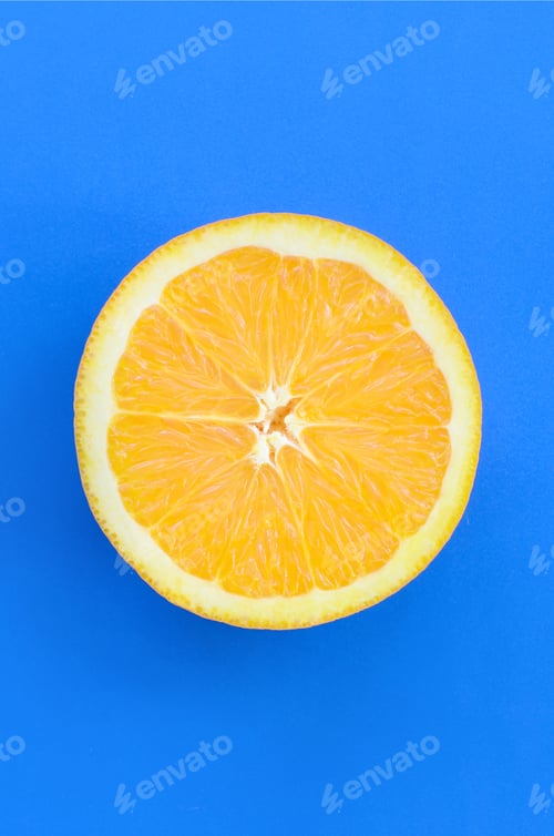 Preview: Top view of a one orange fruit slice on bright background in blue color. A saturated citrus