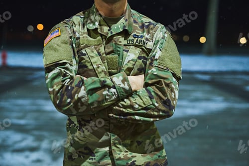 Preview: Cropped shot of a soldier standing outside on a cold night at a military academy