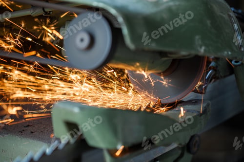 Preview: Closeup shot of an industrial powerful green machine cutting metal surface