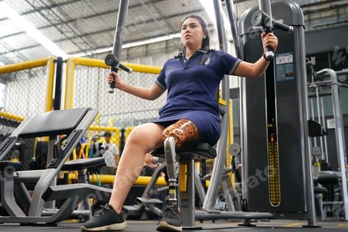 Preview: Young female with one prosthetic leg with shoulder exercises