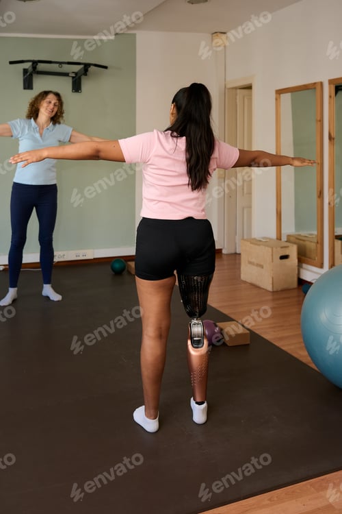 Preview: Woman with prosthetic leg training balance with therapist