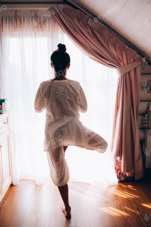 Preview: Woman doing yoga at home