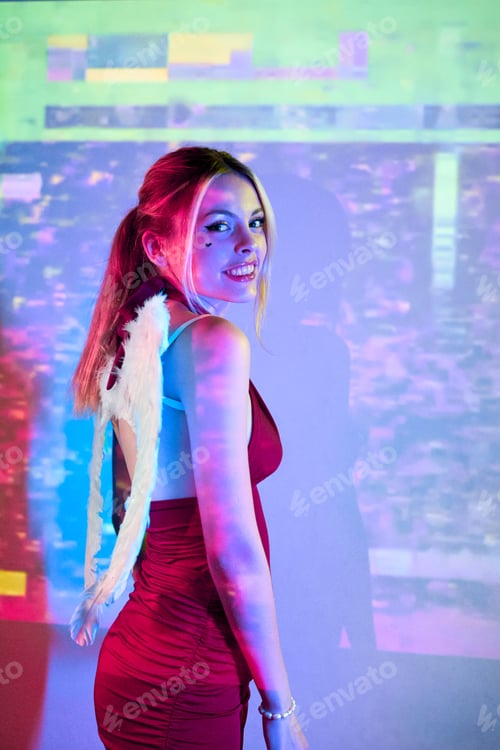 Preview: Portrait of smiling woman with white wings in party atmosphere