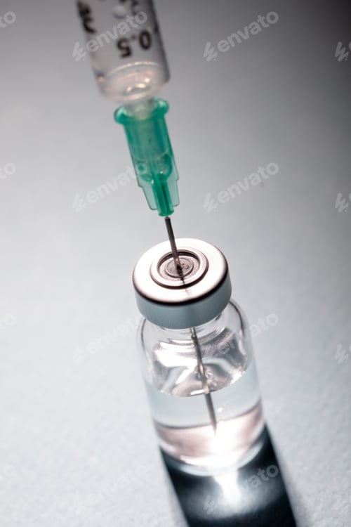 Preview: Vaccine vial dose and syringe against gray blue background