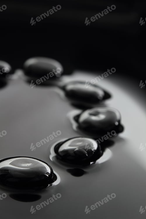 Preview: Black stones on calm water background