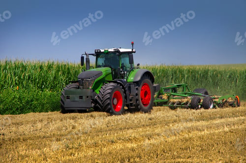 Preview: Modern agricultural tractor working in the field with stubble