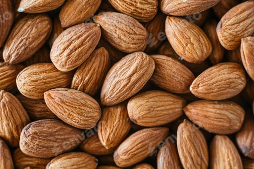 Preview: Close detail of a pile of raw almonds nuts with peel