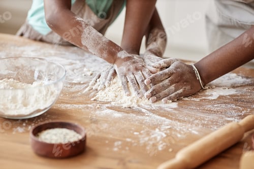 Preview: Mother and daughter baking together in kitchen and kneading dough