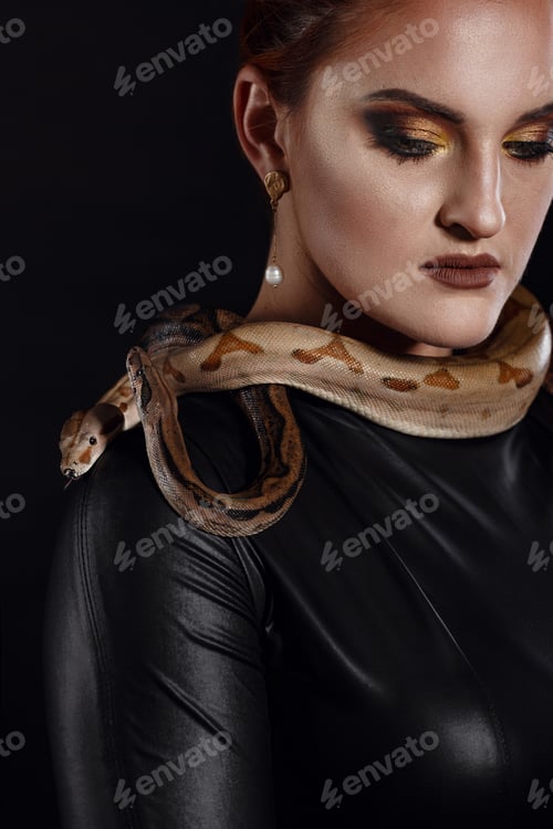 Preview: Close up portrait of sexy woman with snake in latex outfit
