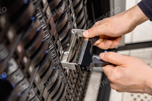 Preview: Male Technician Replacing Server Drive At Datacenter