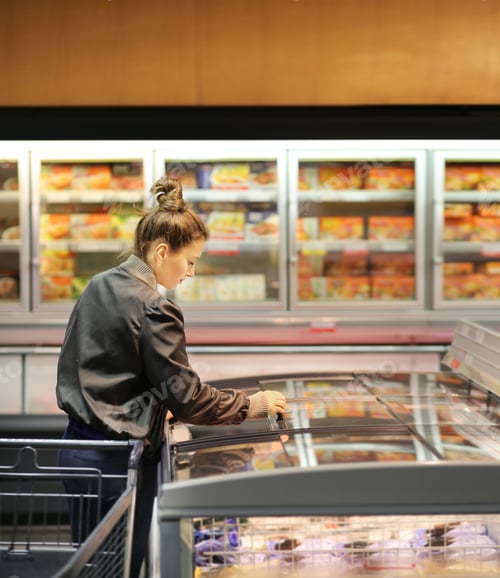 Preview: Woman Choosing Frozen Food From A Supermarket Freezer