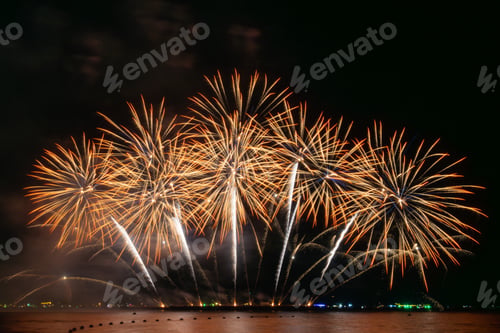 Preview: Red and Green Fireworks Burst Over Water