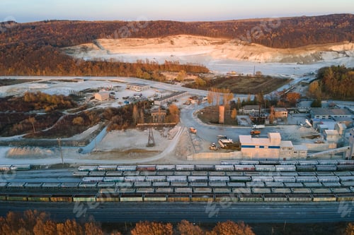 Preview: Aerial view of cargo train loaded with crushed stone materials at mining factory.
