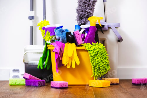Preview: Cleaning products, household chemicals bottles and sprays, rags, sponges in orange bucket
