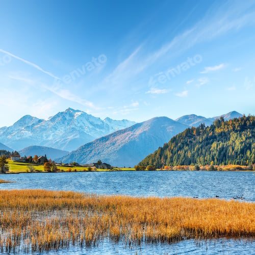 Preview: Gorgeous autumn view of Haidersee (Lago della Muta) lake with Ortler peak on background.
